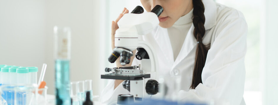 researcher using microscope analyse cell in medical lab.