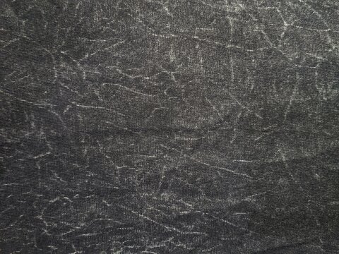 Black acid wash denim texture background with white distressed streaks