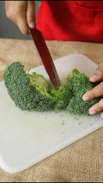 Professional Chef Cutting Fresh Green Broccoli