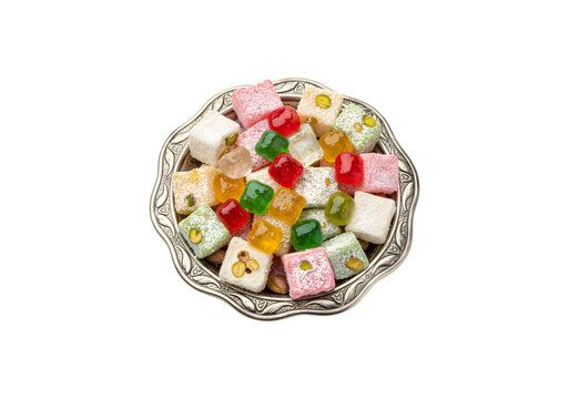 Vibrant akide sweets and Turkish delight served in a classic silver bowl on a white background

