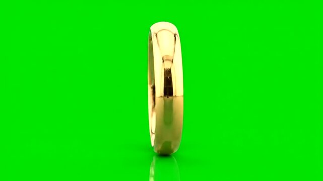 Rotating golden wedding ring on a vibrant green background, elegant concept.