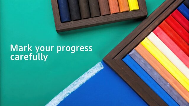 Overhead shot of colorful chalk pastels in wooden frames on blue and green background - Powered by Adobe