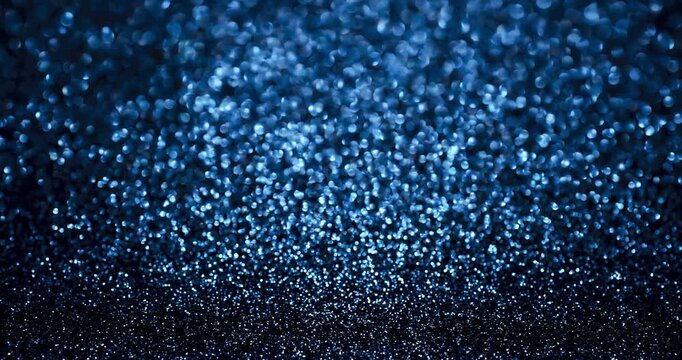 Deep blue glitter bokeh stop-motion animation with shimmering sparkles and soft blur. Ideal for elegant winter, nightlife, tech, and festive abstract backgrounds.