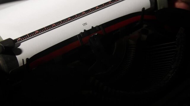 Vintage typewriter striking the letters ufo on aged paper, evoking secrets, classified reports, conspiracy research and eerie, suspenseful investigations into the unknown