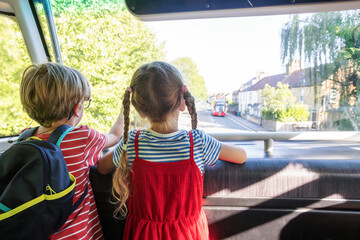 Children travelers enjoying a double decker bus ride at summer © Sergey Novikov