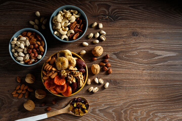 Mixed nuts and dried fruit on a wooden background. Symbols of Jewish holiday Tu Bishvat.