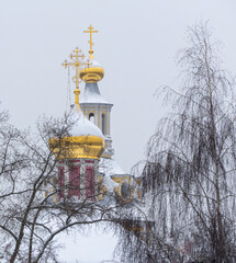 A church steeple with a cross on top and a gold cross on top of it