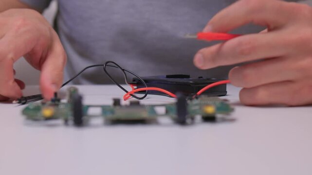 Technician checks solder joints carefully, Using multimeter to identify faults precisely, Technician meticulously inspects solder connections with multimeter on small work area