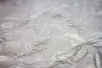 Extreme macro of plastic bubble wrap texture. Selective soft focus, shallow depth of field. Abstract dreamy background