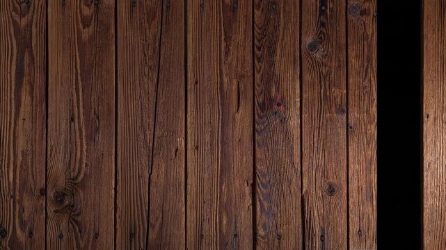 Rustic dark brown wooden planks with visible grain and knots, creating a textured background