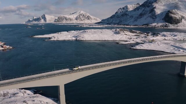 Aerial View of Car Crossing Fredvang Bridge in Winter Norway