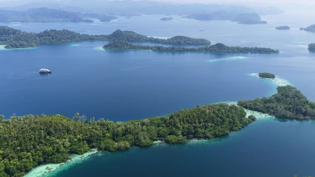 Shallow coral reefs fringe the beautiful islands of Pef, Raja Ampat, Indonesia. This region harbors spectacular marine biological diversity and is a popular destination for divers and snorkelers.