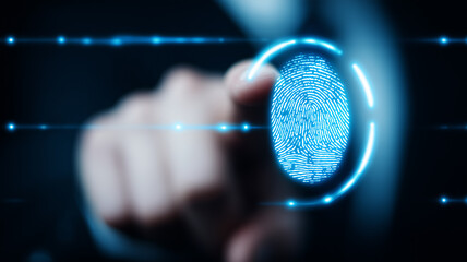 A glowing fingerprint interface scanned by a human finger, representing biometric authentication and digital identity verification technology.
