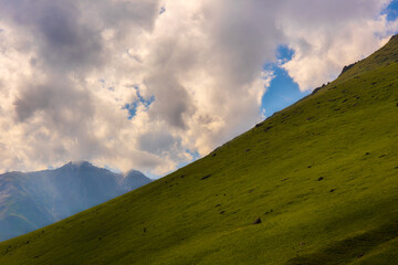 Serene mountain landscape captured during daytime. Majestic peaks rise against clear blue sky, creating a peaceful and dramatic atmosphere in the outdoors.