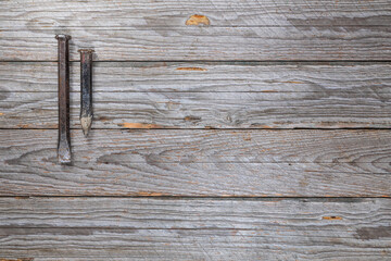 Two Worn Metal Chisels on Weathered Wooden Workbench, Top View
