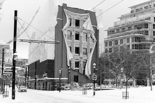 black and white view of Flatiron Mural by Derek Besant located at 50 Park Path, west facing wall of Gooderham Building, after a winter storm in Toronto