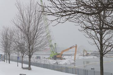 Naklejka premium heavy equipment at Ontario Place redevelopment during a snow storm on 2026-01-15 in Toronto