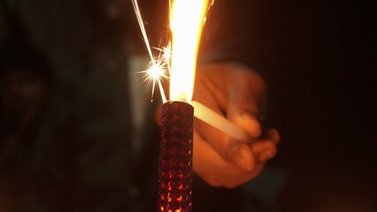 hand holding a burning candle