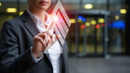 Businesswoman touches a bright glowing upward arrow, symbolizing significant business growth and future success.