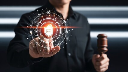 Man's finger interacts with a holographic shield icon surrounded by a digital interface, while holding a wooden gavel.