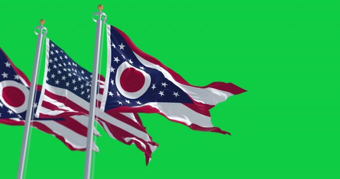 Ohio and national US flags waving in the wind isolated on green background