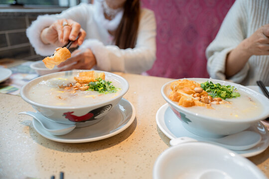 Pork porridge with coriander and ginger or porridge is similar to rice porridge but softer in texture. Served on a marble table with patongko. For breakfast in the morning or evening