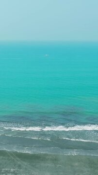 Aerial view of a serene turquoise ocean meeting a sandy beach relaxing nature