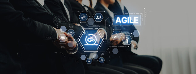 A professional team participates in agile methodology training, surrounded by a digital interface showcasing project management concepts and collaboration techniques. Trope