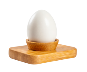 Single white chicken egg sitting upright in a natural bamboo egg cup holder with a square base, representing a healthy and nutritious breakfast meal in a minimalist style