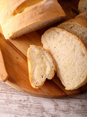 Homemade sourdough white bread, sliced on wooden board