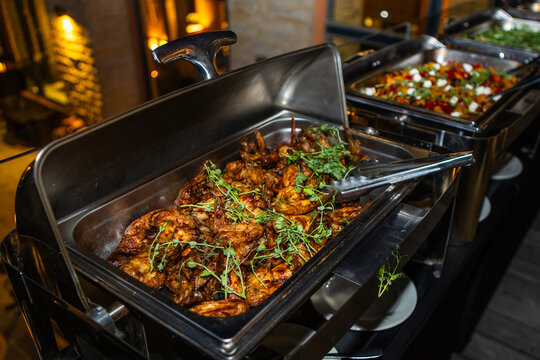 Grilled chicken with basting in a silver tray