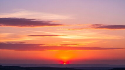 Obraz premium Vibrant sunset painting the sky with hues of orange and purple, a serene natural spectacle