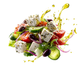 Fresh Greek salad with feta cheese, tomatoes, and olives is captured mid-air with a dynamic splash of golden olive oil dressing and sprinkled with aromatic herbs
