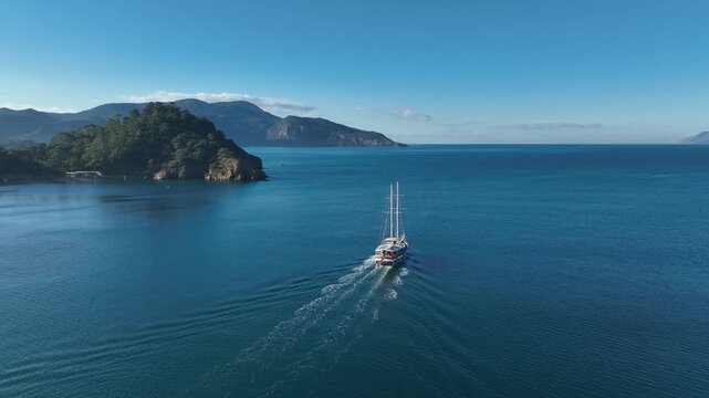 Sailing Serenity: A majestic sailing ship gracefully glides across the tranquil turquoise waters, framed by a scenic coastal landscape, painted against a vibrant blue sky.