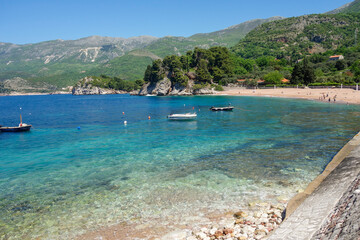 amazing Sveti Stefan beach in Budva riviera. Crystal clear waters on a sunny day