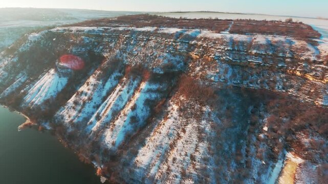 FPV drone aerial shot. Beautiful nature landscape in winter of the Dniester River with a mountain bank. Moldova, Europe