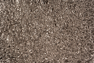 Shiny silver foil background. Top view.