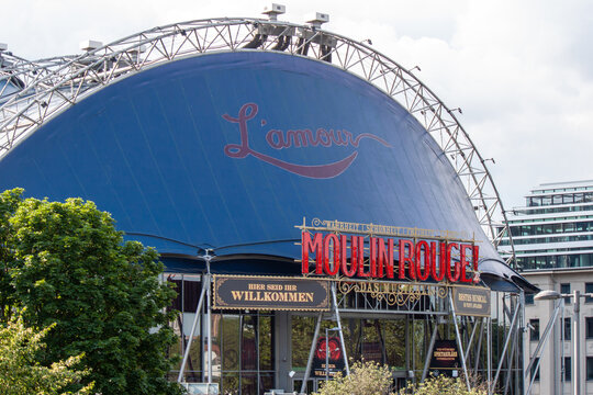 The blue Musical Dome theater featuring a large Moulin Rouge sign for the musical production. Modern entertainment venue in the city center