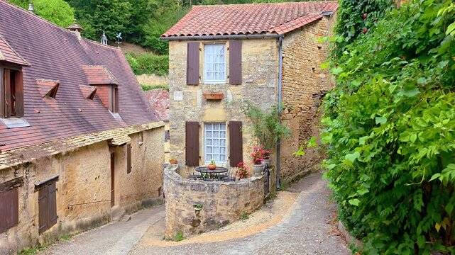 Picturesque corner of the beautiful Dordogne village of Beynac et Cazenac, France. Handheld walking motion.