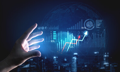 A hand reaches out to interact with virtual data visualizations, showcasing growth, statistics, and analytics in a modern business environment with futuristic elements. Scalp