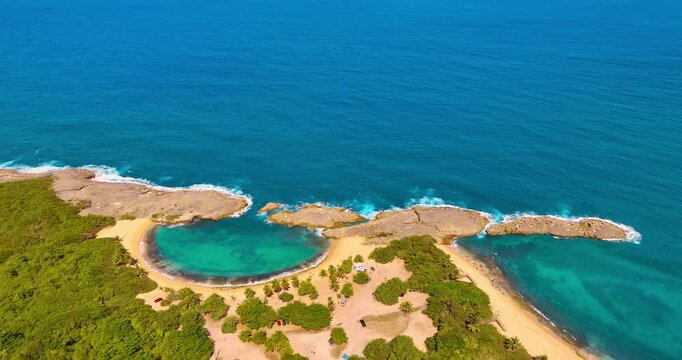 Approaching Mar Chiquita Beach in Manati, Puerto Rico. Picturesque shore with turquoise water from the Atlantic Ocean. Aerial view.