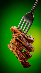 A fork with three pieces of meat on it