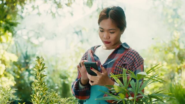 Woman Using Smart phone in Lush Garden