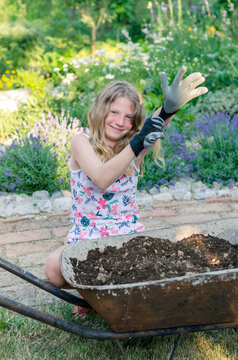 girl preparing soil for spring planting