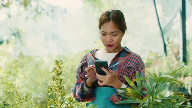 Woman Using Smart phone in Lush Garden