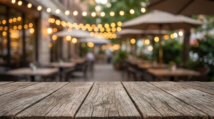 Empty wooden table with blurred restaurant patio and string lights