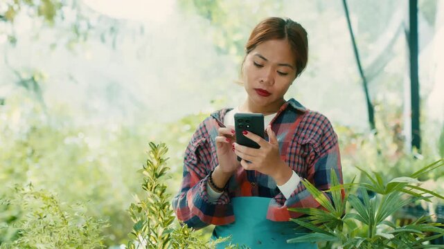 Woman Using Smart phone in Lush Garden
