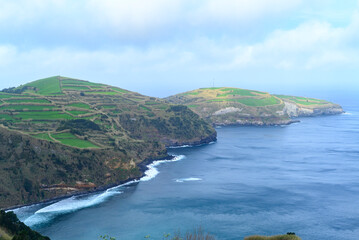 Green agricultural terraces on the cliffs of a volcanic island in the Atlantic