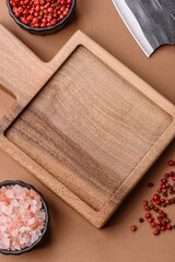 Fototapeta premium Empty wooden cutting board with a knife for food preparation. An empty wooden cutting board