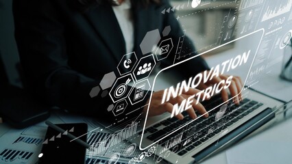 Business professional analyzing innovation metrics on a laptop with graphic elements for data visualization and analytics. Asymptotic smart data analytic.